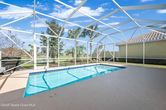 view of pool featuring a patio area and glass enclosure