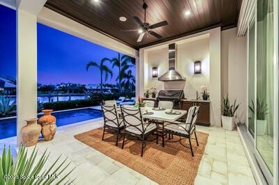 patio terrace at dusk featuring ceiling fan