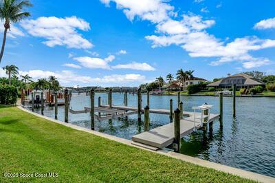 view of dock featuring a water view and a lawn