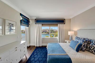 bedroom featuring ornamental molding and dark hardwood / wood-style flooring