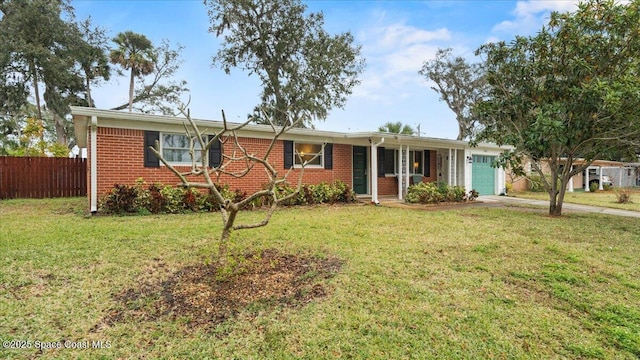 ranch-style home featuring a garage and a front lawn