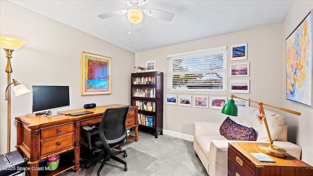 office with light carpet and ceiling fan