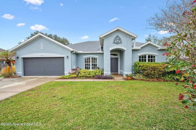 ranch-style house featuring a garage and a front yard