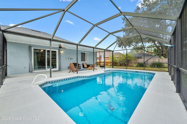 view of pool with a lanai, a patio, and ceiling fan