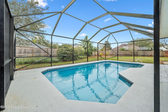 view of swimming pool with a lanai, a patio area, and a lawn