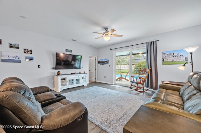 living room featuring hardwood / wood-style floors and ceiling fan