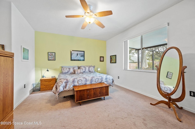 bedroom with light colored carpet and ceiling fan