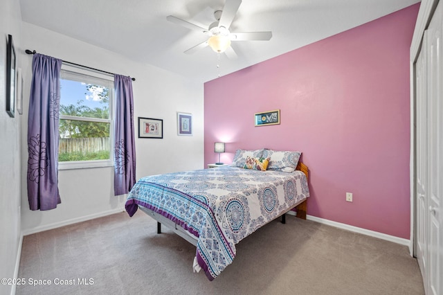 bedroom featuring ceiling fan, light carpet, and a closet