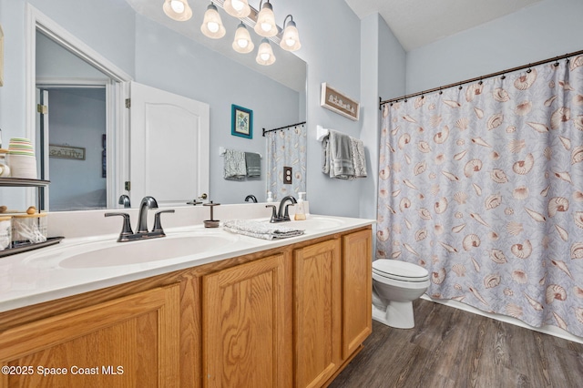 bathroom featuring vanity, hardwood / wood-style floors, and toilet