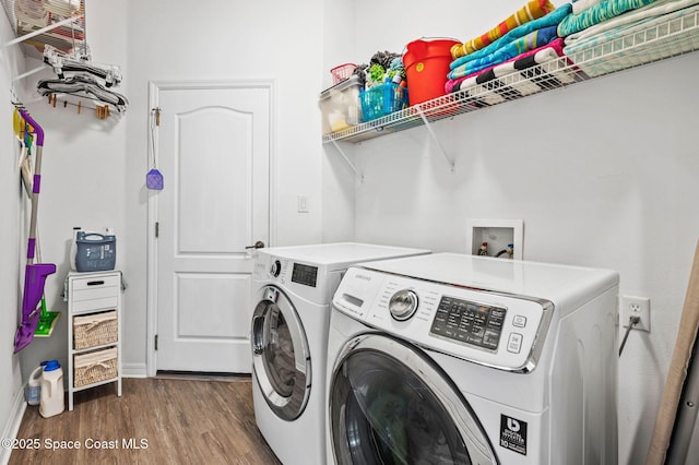 washroom with independent washer and dryer and hardwood / wood-style floors