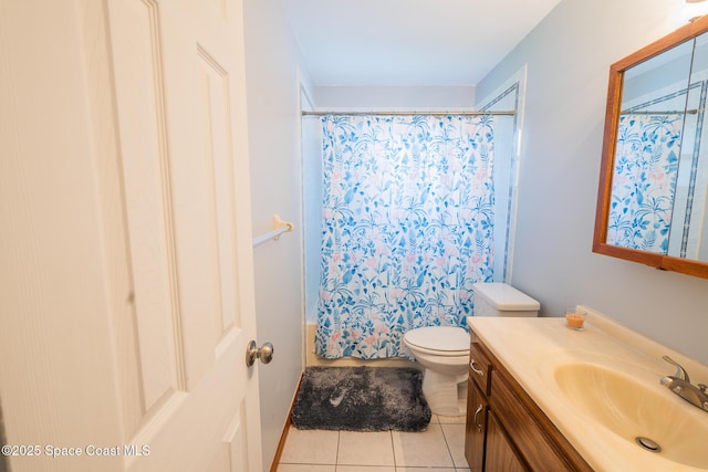 bathroom featuring tile patterned floors, vanity, and toilet