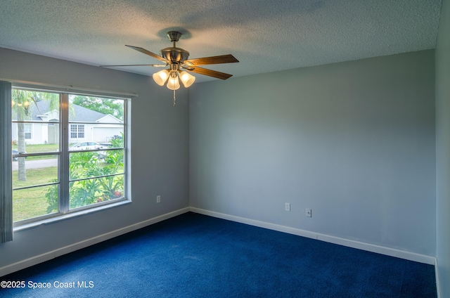 carpeted spare room with ceiling fan and a textured ceiling