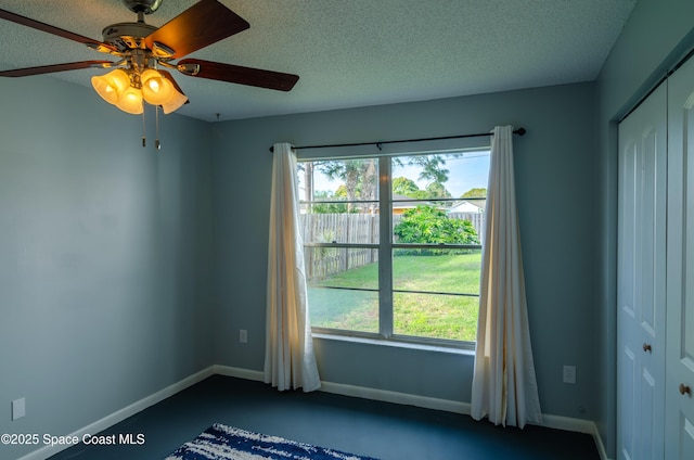 spare room featuring a textured ceiling and a wealth of natural light