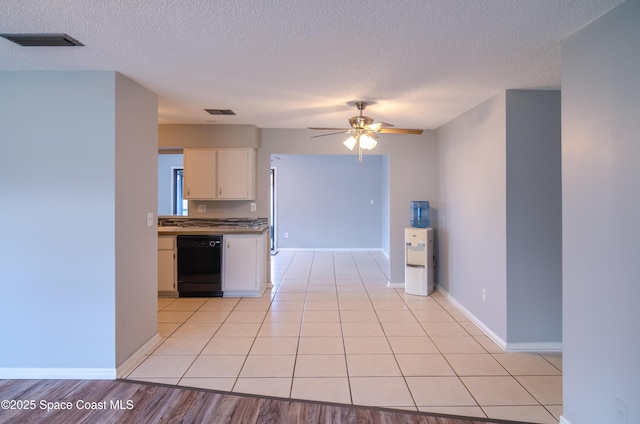 kitchen featuring white cabinetry, a textured ceiling, black dishwasher, ceiling fan, and light hardwood / wood-style floors