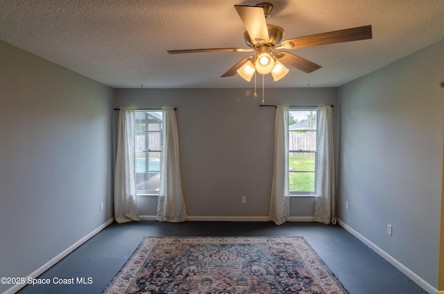 spare room featuring ceiling fan and a textured ceiling