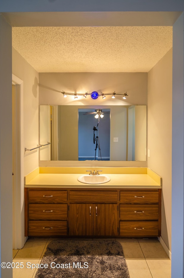 bathroom featuring vanity, tile patterned flooring, and a textured ceiling