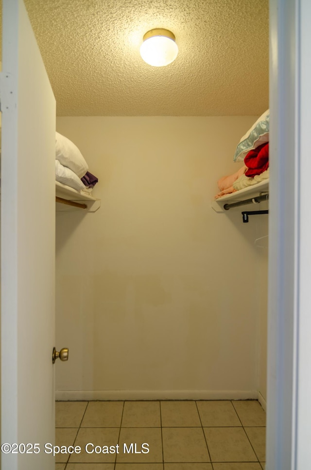 spacious closet with light tile patterned flooring