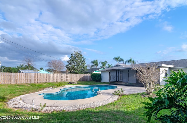 view of swimming pool featuring a lawn and a patio