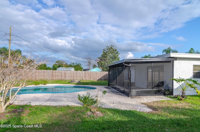 view of pool featuring a lawn, a sunroom, and a patio