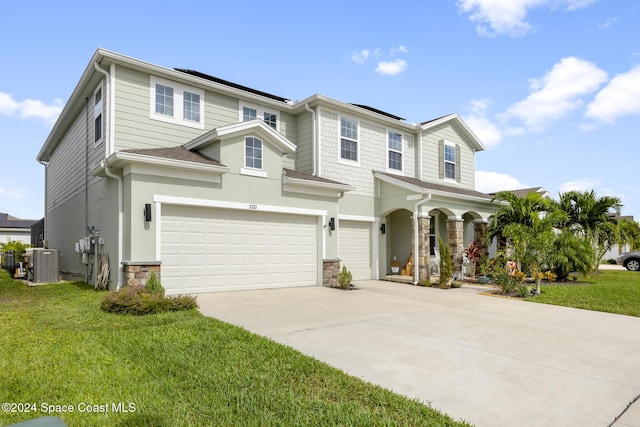 view of front of property with cooling unit, solar panels, covered porch, a garage, and a front lawn