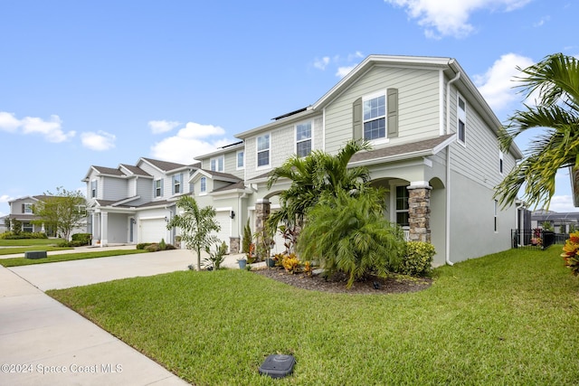 view of front of home featuring a garage and a front yard