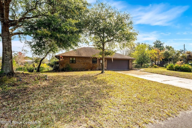 ranch-style home with a garage and a front lawn