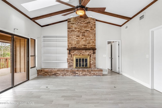 unfurnished living room with ceiling fan, lofted ceiling with skylight, and a brick fireplace