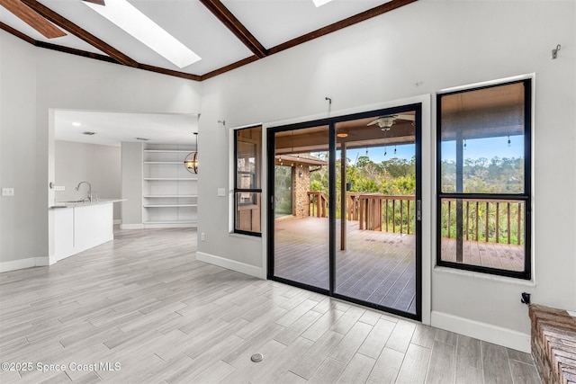 entryway featuring lofted ceiling with skylight, sink, and built in features