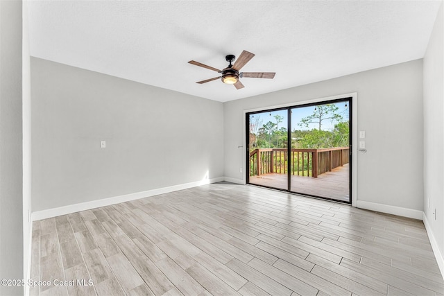 empty room with a textured ceiling, ceiling fan, and light hardwood / wood-style flooring