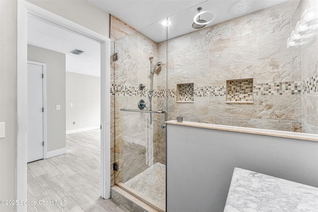 bathroom featuring a shower with shower door