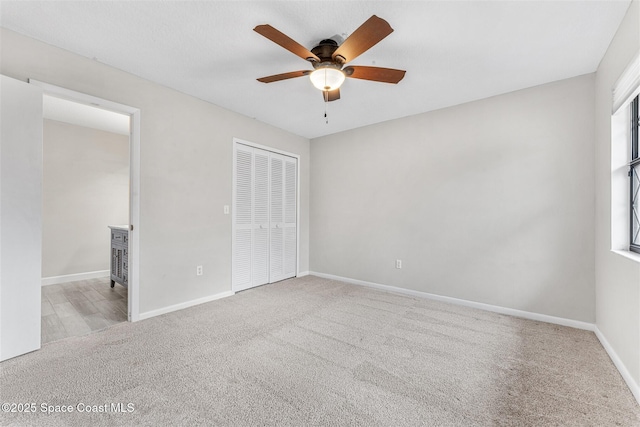 unfurnished bedroom with light carpet, a closet, and ceiling fan