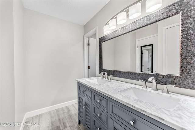 bathroom with vanity, hardwood / wood-style flooring, and a textured ceiling