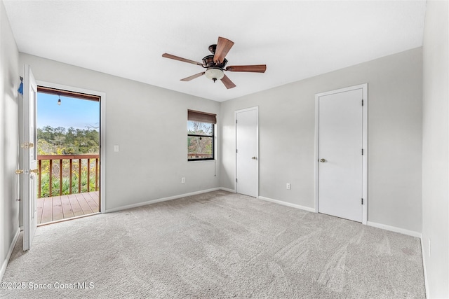 unfurnished bedroom featuring light carpet, access to outside, and ceiling fan