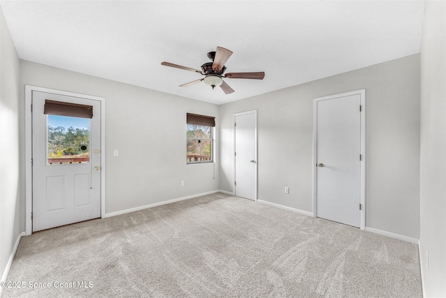 carpeted empty room with ceiling fan