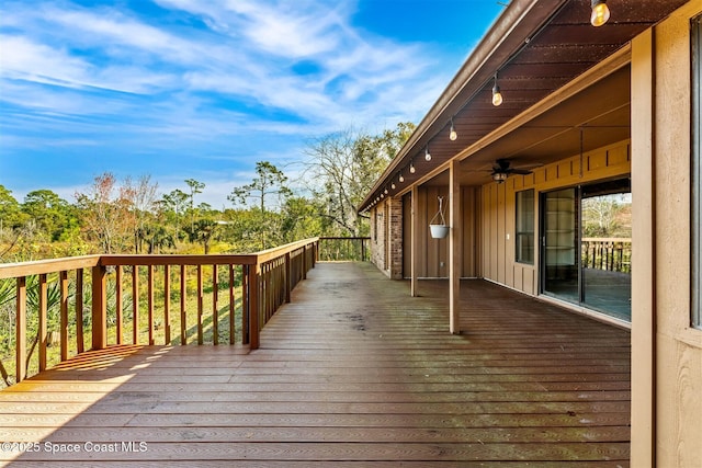 wooden deck featuring ceiling fan