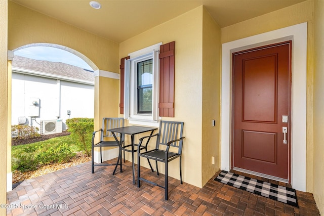 doorway to property featuring ac unit