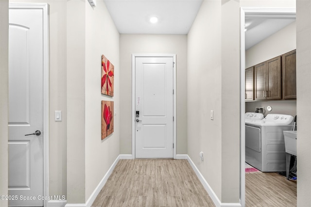 interior space featuring separate washer and dryer and light hardwood / wood-style floors