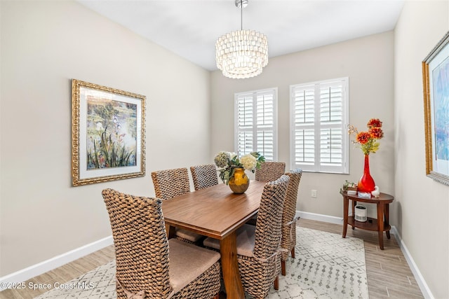 dining room with a chandelier and light hardwood / wood-style floors