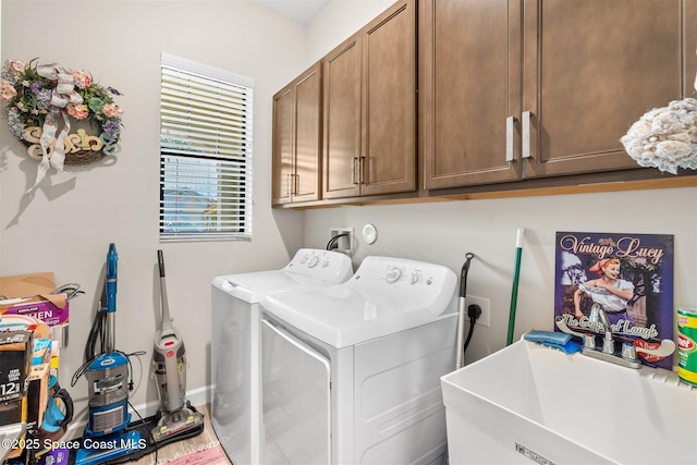 laundry room featuring cabinets, sink, and washing machine and dryer