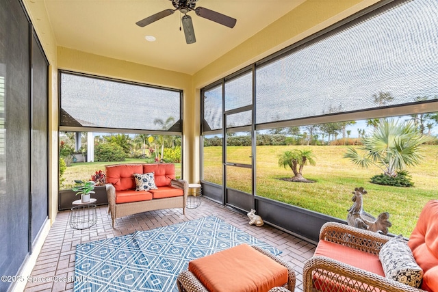 sunroom / solarium featuring ceiling fan