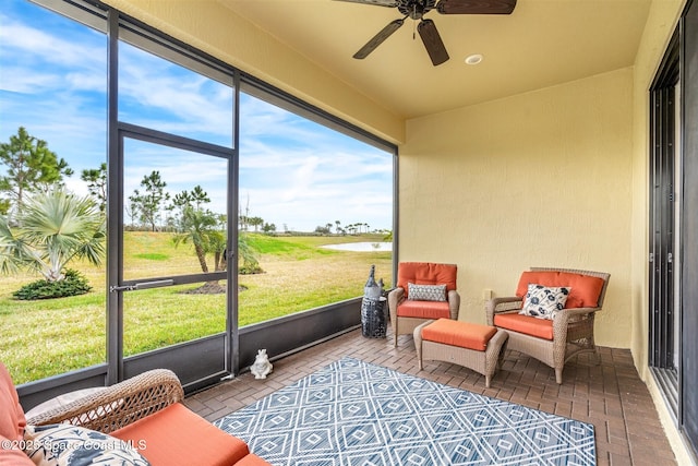 sunroom featuring ceiling fan