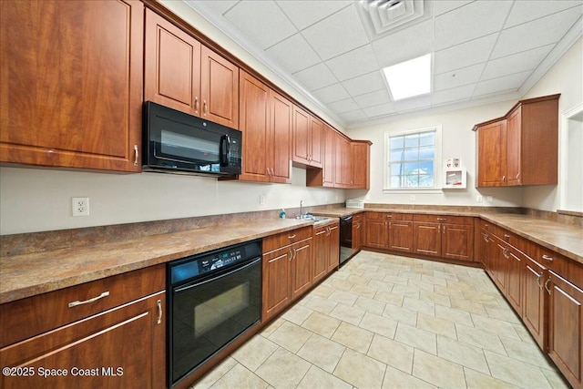 kitchen featuring sink, crown molding, and black appliances