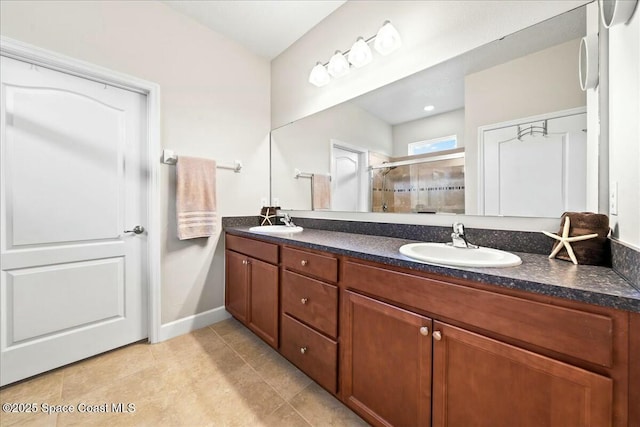 bathroom with tile patterned flooring, vanity, and a shower with shower door