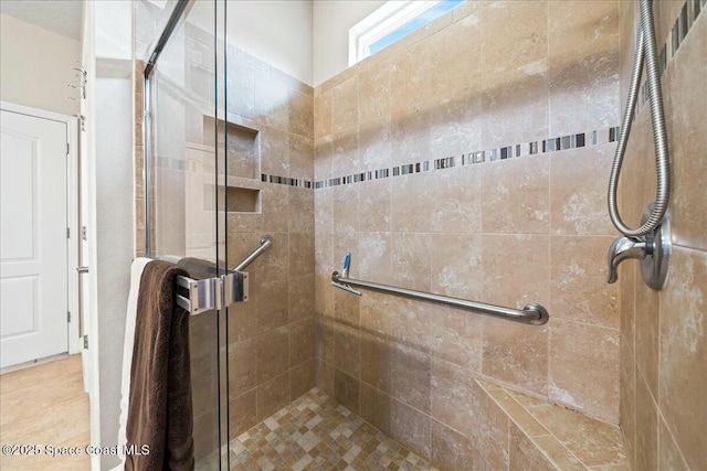 bathroom featuring a shower with shower door