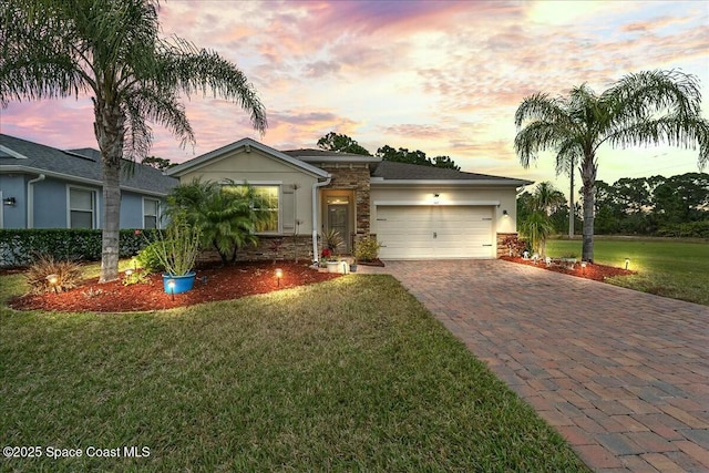 view of front of property with a yard and a garage