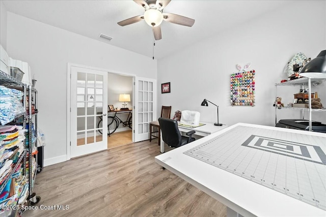 office featuring french doors, ceiling fan, and light wood-type flooring