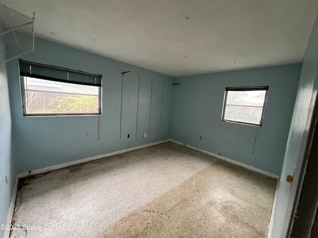 unfurnished room featuring plenty of natural light