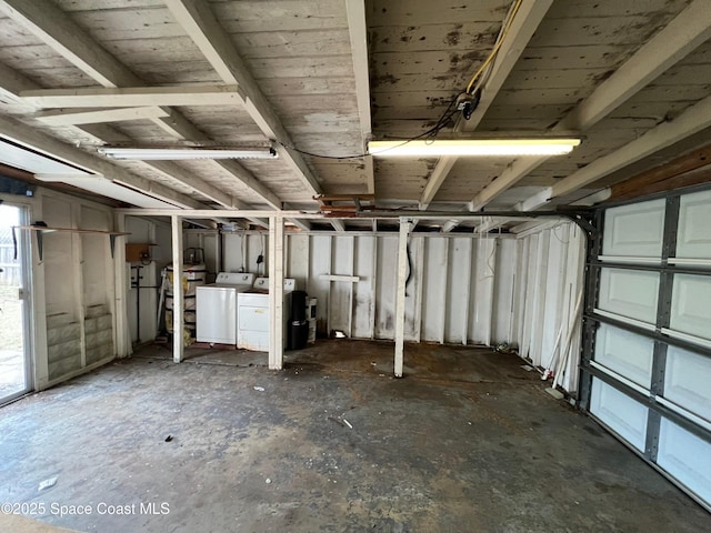 garage with washer and clothes dryer