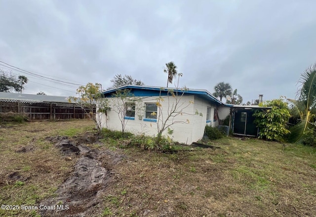 rear view of property with a yard