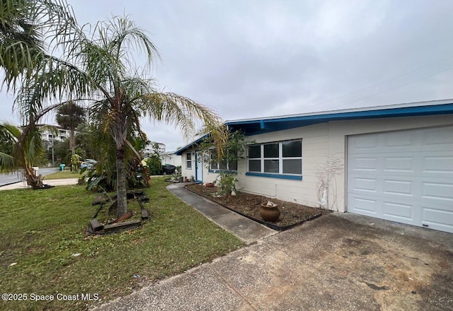 view of front of property with a garage and a front lawn